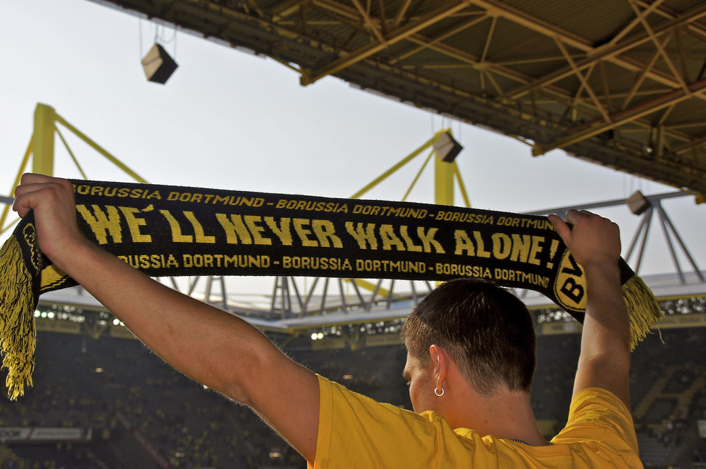 A Borussia Dortmund fans holds his scarf aloft at Signal Iduna Park