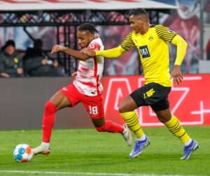 Manuel Akanji of Borussia Dortmund goes up against RB Leipzig's Christopher Nkunku